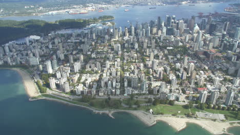 downtown vancouver and sunset beach helicopter shot looking east in british columbia