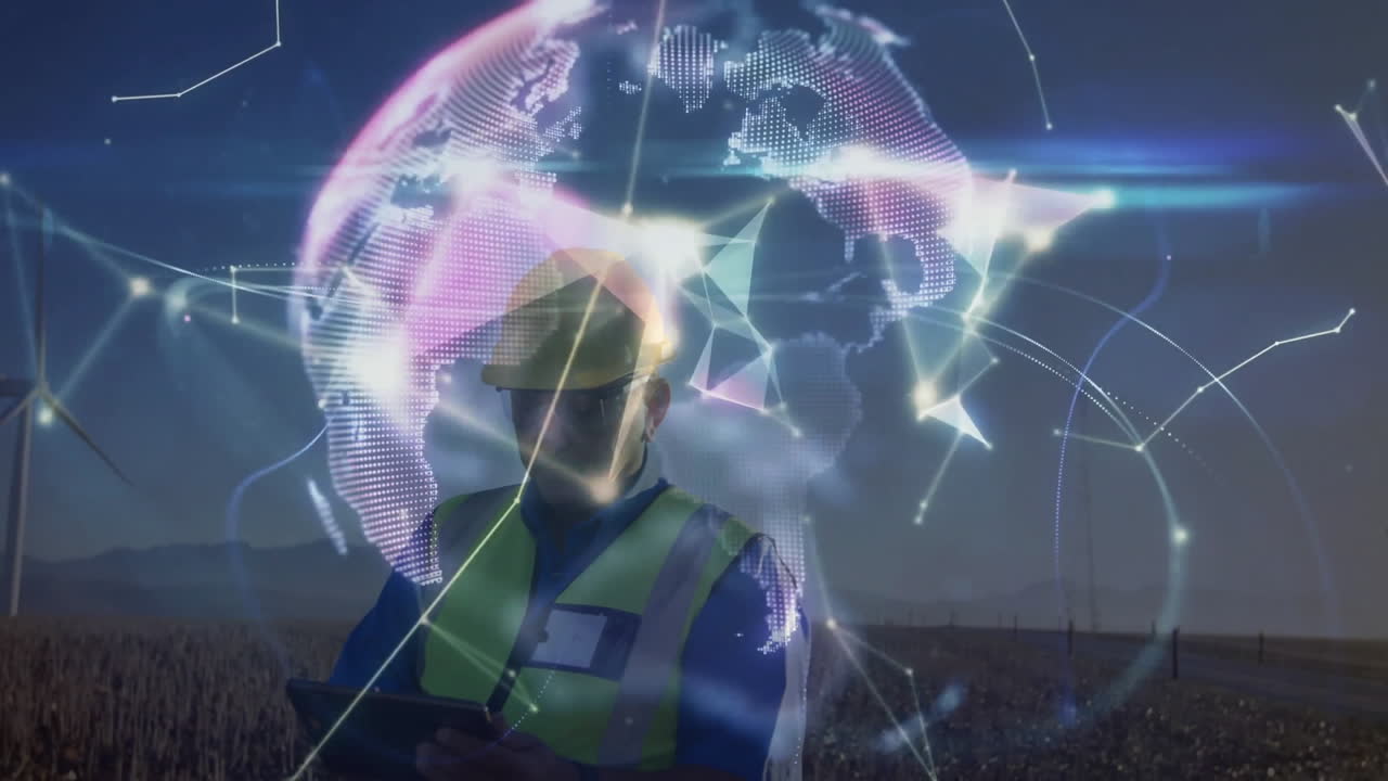 Engineer using tablet in wind farm, with data globe overlay visualizing network in energy