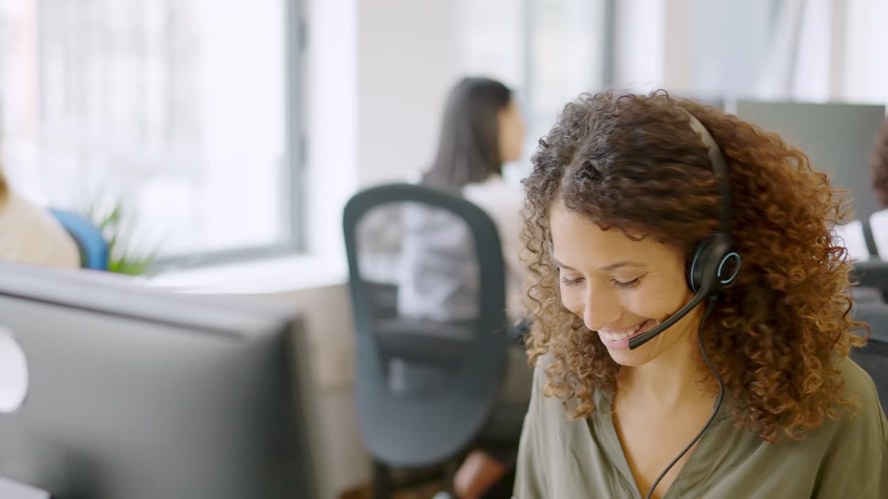 Telephone operator answering with a smile in a coworking space