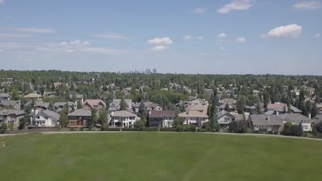 city skyline is revealed behind a neighborhood