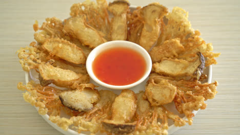 deep fried enoki mushroom and king oyster mushroom with spicy dipping sauce - vegan food style