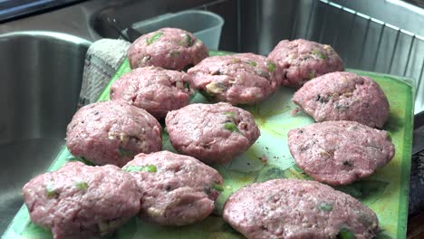 African-American-female-hands-only,-seasoning-homemade-turkey-burgers