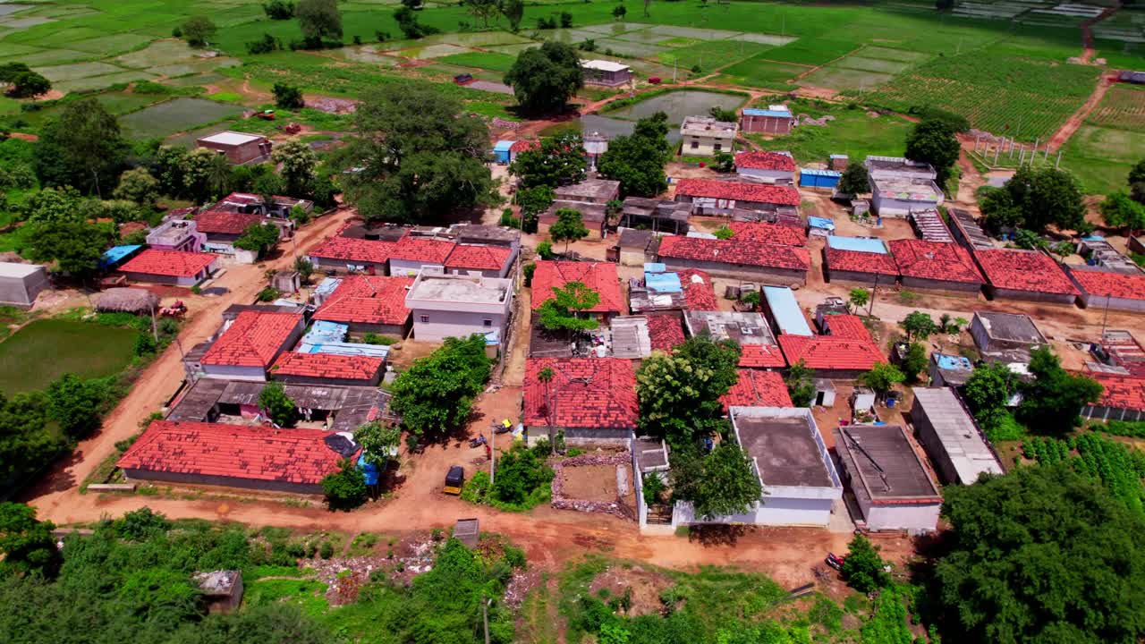old construction houses with crop fields lands in telangana villages at tekmal village, medak district, telangana, india. day time, semi orbit, drone shot, 4k.
