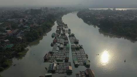 floating fish farming community in bien hoa on the dong nai river, vietnam on a sunny day