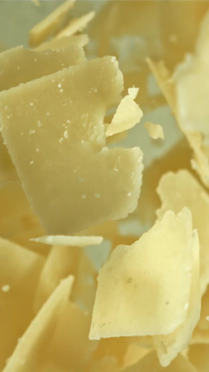 Parmesan Cheese Flakes Falling in Slow Motion