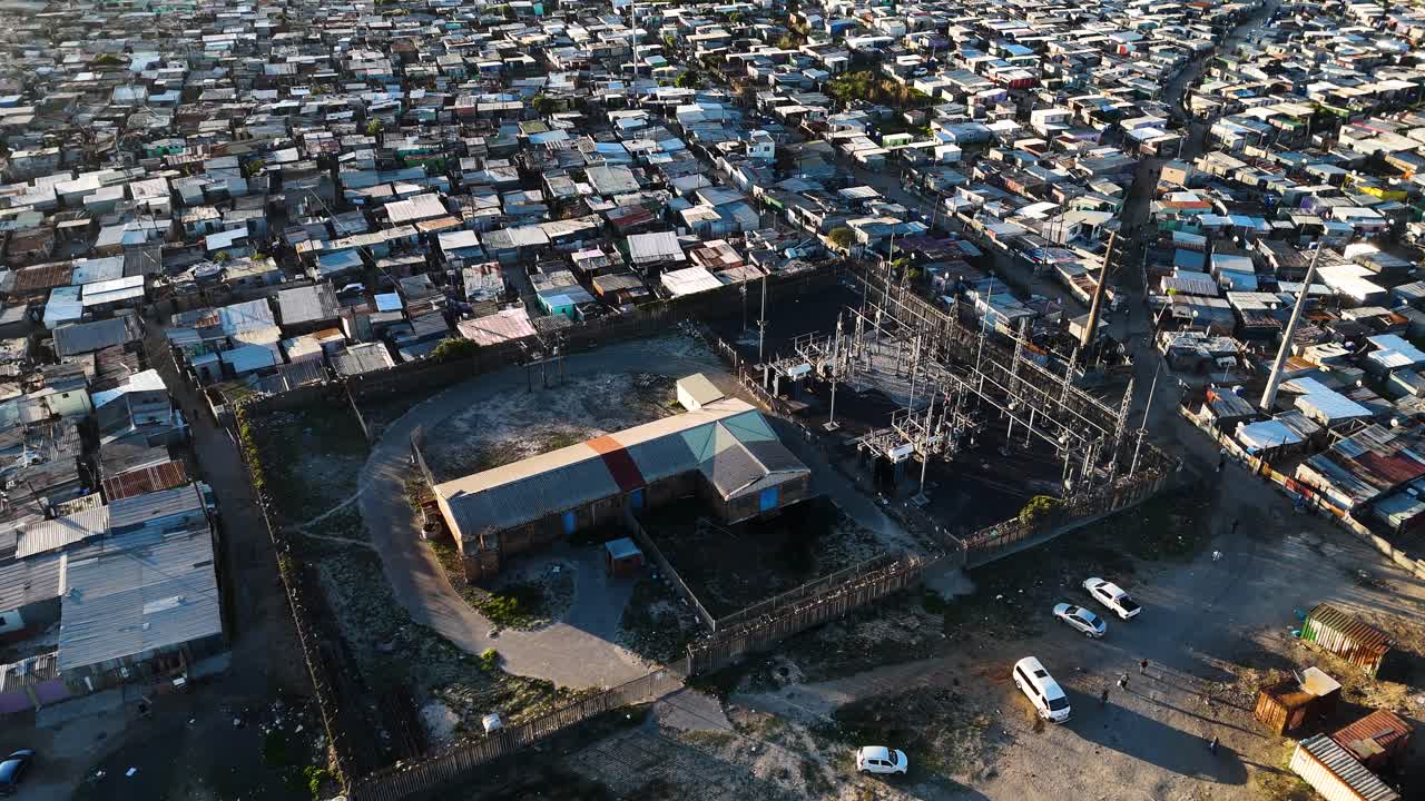 Aerial view of an information settlement in South Africa showing how people live in overcrowded areas with a power station in the foreground
