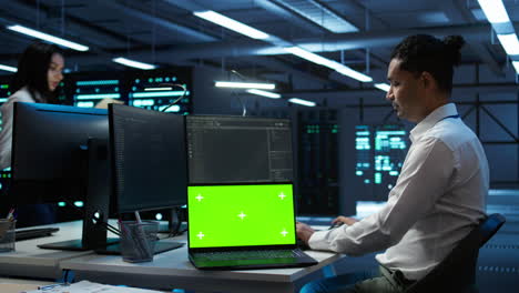 Woman-doing-maintenance-on-server-room-infrastructure-using-mockup-laptop