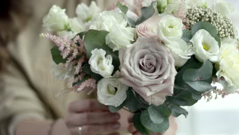 young florist assembles a rustic wedding bouquet