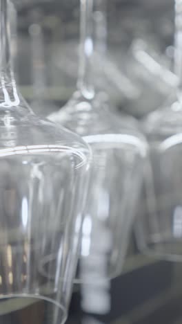 clean wine glasses hanging in a bar