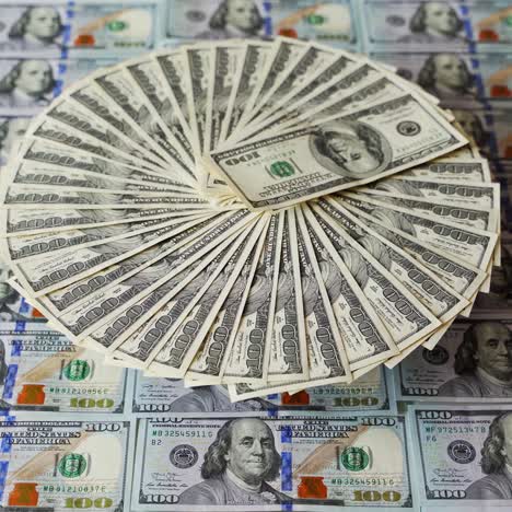 hundred dollar bills arranged in a circular fan