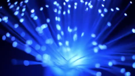colorful lights pulse and radiate in captivating patterns, showcasing a captivating light display. spectators admire the vibrant blue illumination in an enchanting nighttime atmosphere.