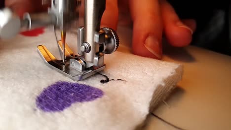 mujer está cosiendo corazones en una tela blanca con signos de corazón para el día de san valentín