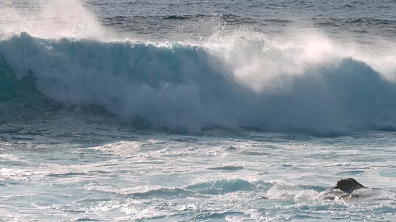 Dramatic ocean waves collide with the volcanic coastline near Timanfaya National Park, located on the island of Lanzarote in the Canary Islands, Spain.