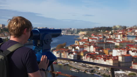 tourist on telescope viewer in serra do pilar monastery in vila nova de gaia city, portugal. rack focus shot