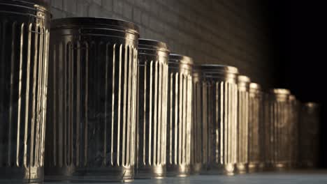 steel trash bins stacked together in an endless loop. sunlight illuminates shiny metal lids on a vast field full of containers with garbage waste. symbol of growing pollution and rubbish outgrowth.