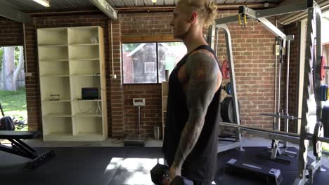 tattoo man muscles in home gym doing bicep curls strict