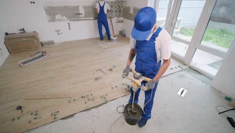 installing ceramic floor tiles - measuring and cutting the pieces. construction, renovation, repair apartment. cuts tile. tile cutting