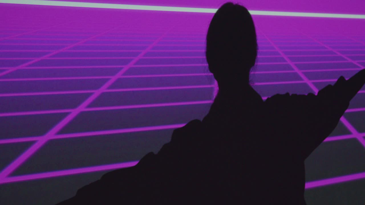 Silhouette Of Woman Visiting Immersive Art Exhibition With Projection Of Grid On Wall 1