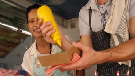 Waiter-preparing-meal-for-customer