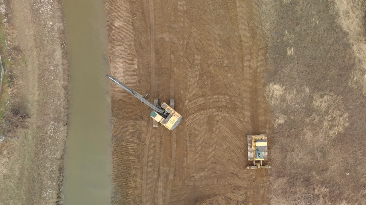 Aerial View of Two Excavator working togheter as Natural calamities prevention and control the canal river water