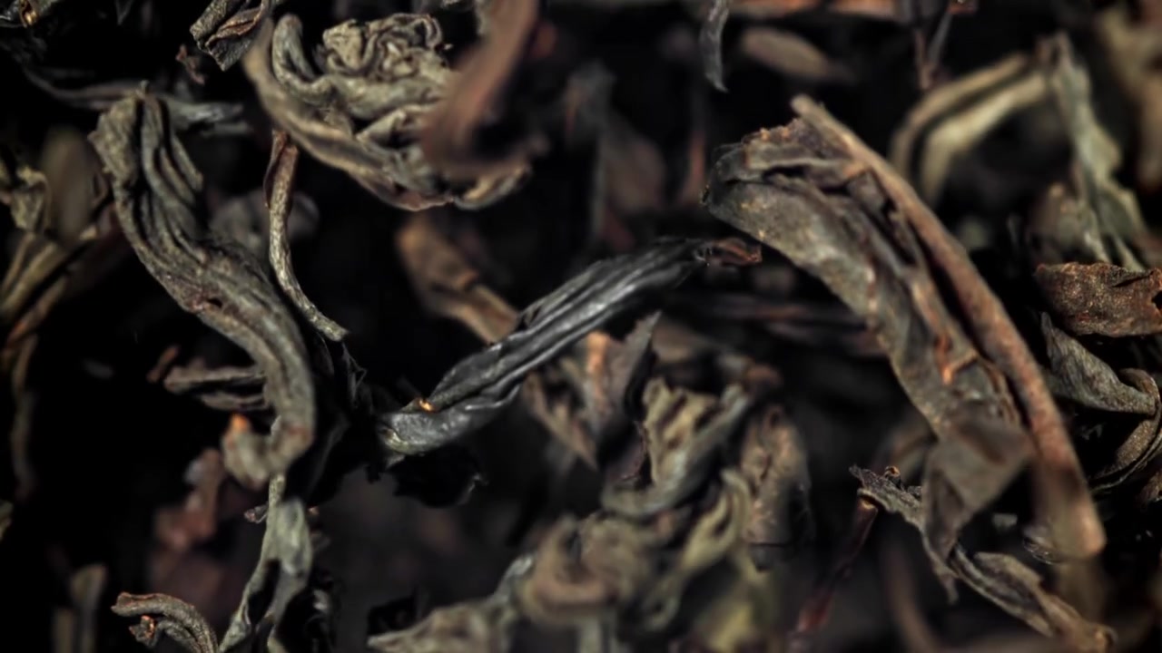 Dry Black Tea Leaves Falling in Slow Motion