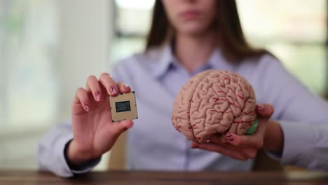 woman holding a cpu and a brain model, representing ai and neuroscience