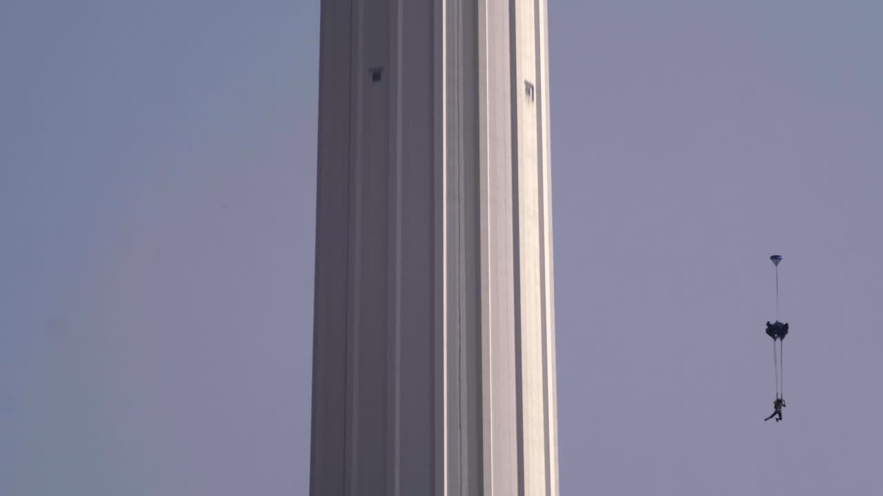 Base jumpers jumping from Menara tower in Kuala Lumpur.