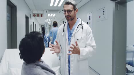 Doctor-talking-with-patient-in-hospital-corridor-4k