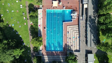 spectacular aerial top view flight public swimming pool insulaner, city berlin germany summer day 2023