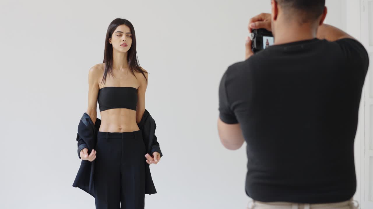 Fashion photoshoot with a model and a photographer in a studio