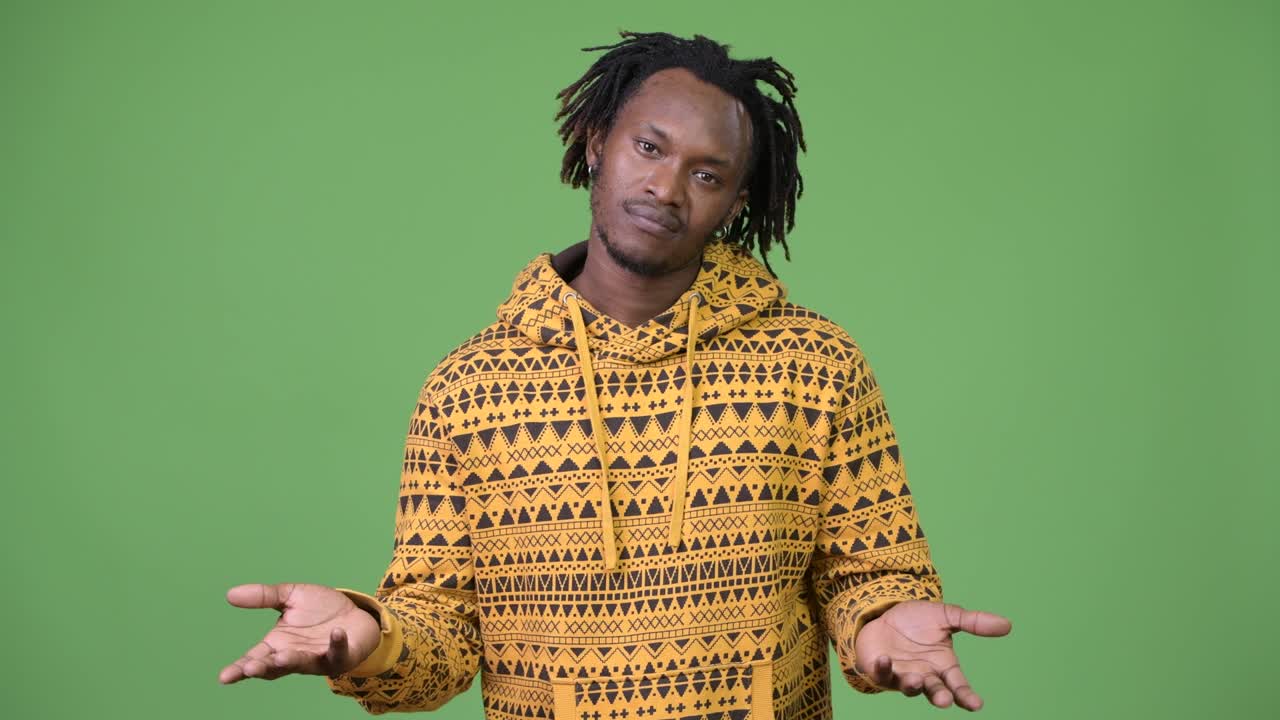 Young handsome African man shrugging shoulders