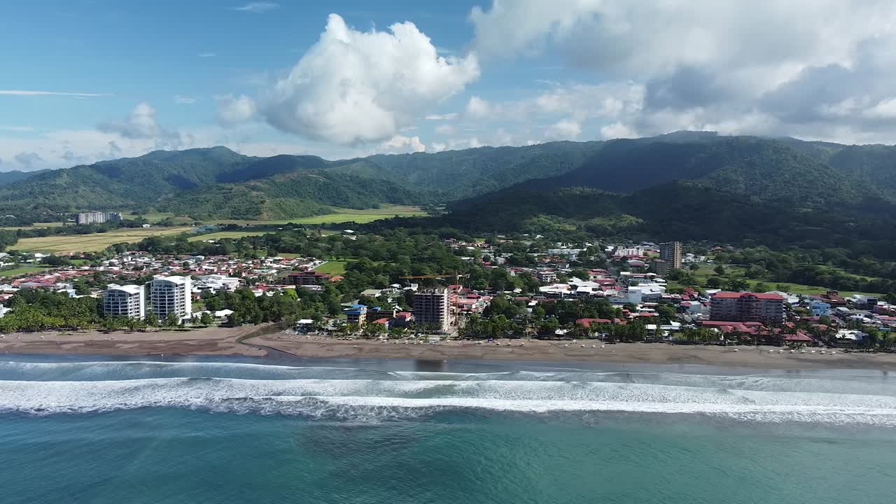 Beautiful drone shot flying over the black sand beach in Jac&oacute;, Costa Rica