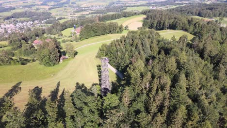 aerial high drone shot flying around the pfannenstiel observation tower in the canton of zürich, switzerland