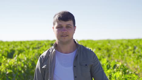 Working-farmer-walking-in-vineyard-looking-at-camera.