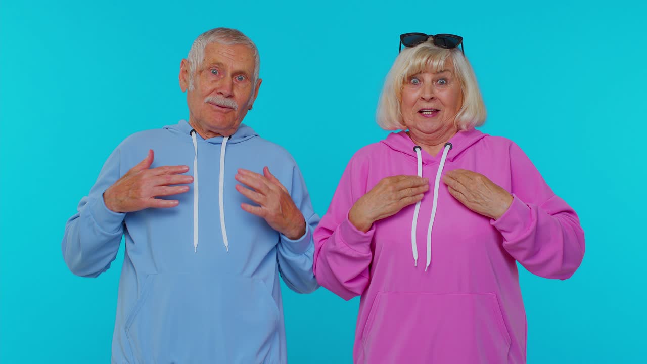 Senior grandfather grandmother feeling very proud pointing themselves, overjoyed by success win