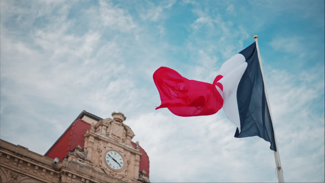 French flag waving in front of the Mairie de Cannes Town hall in Cannes, France