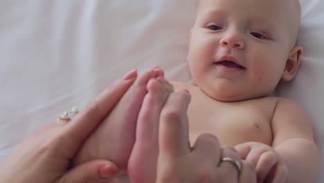 A-woman-playing-with-baby-daughter-feet