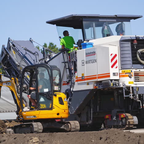 special machinery during roadworks. asphalt replacement on the highway on a summer day. road rollers working on new road construction site.