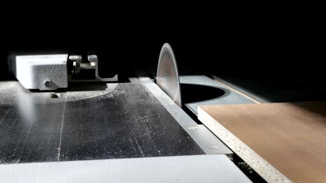 4k close-up of a circular saw cuts the particle wooden board.