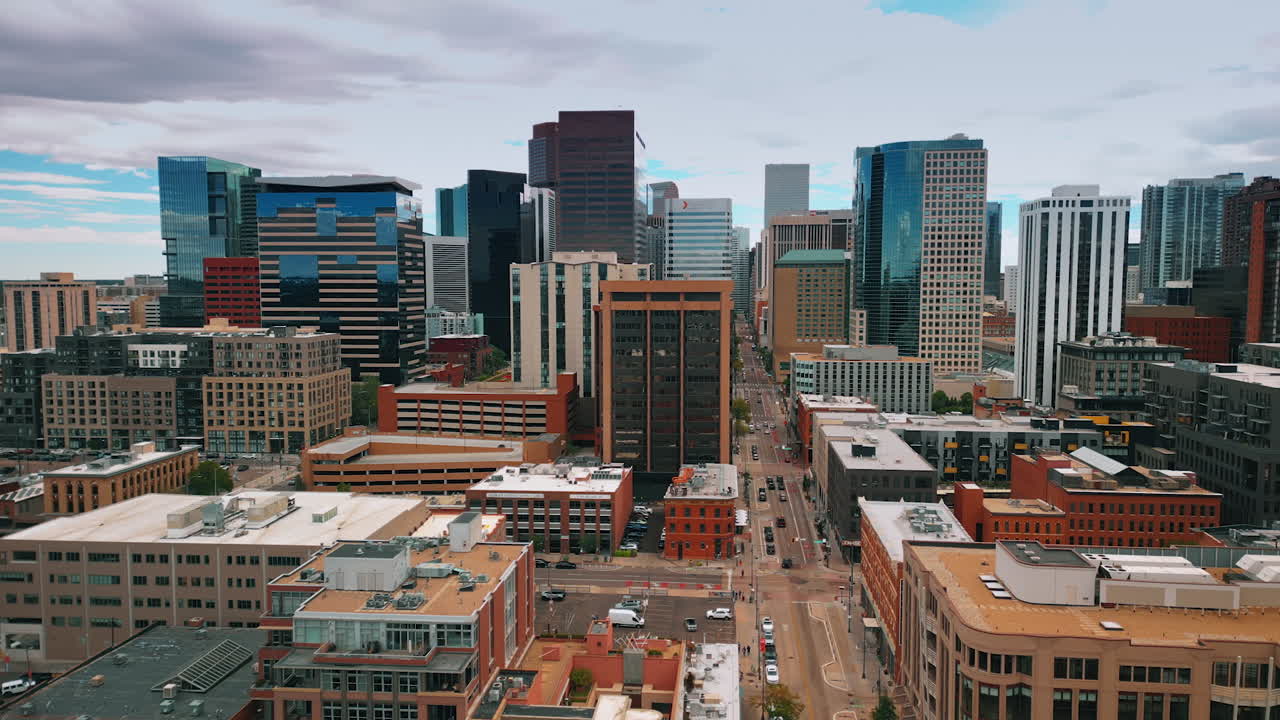 Denver, USA, 28 July 2025: Flight above the modern cityscape of Denver, Colorado, USA. Revealing view on the long straight street with traffic in the scenery