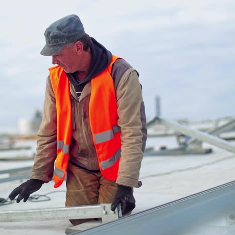 technicians building metal base for solar panels. metal basis installation. workers construct new solar farm on a roof.