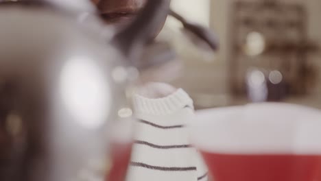 a woman brewing coffee or tea with a kettle