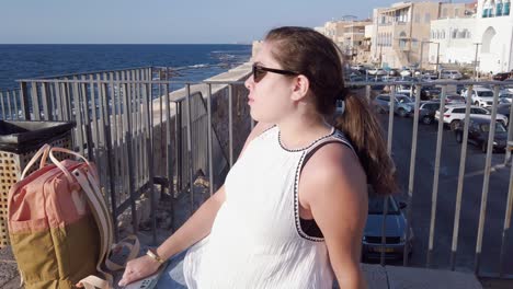 tourist enjoying view of mediterranean sea in acre, israel