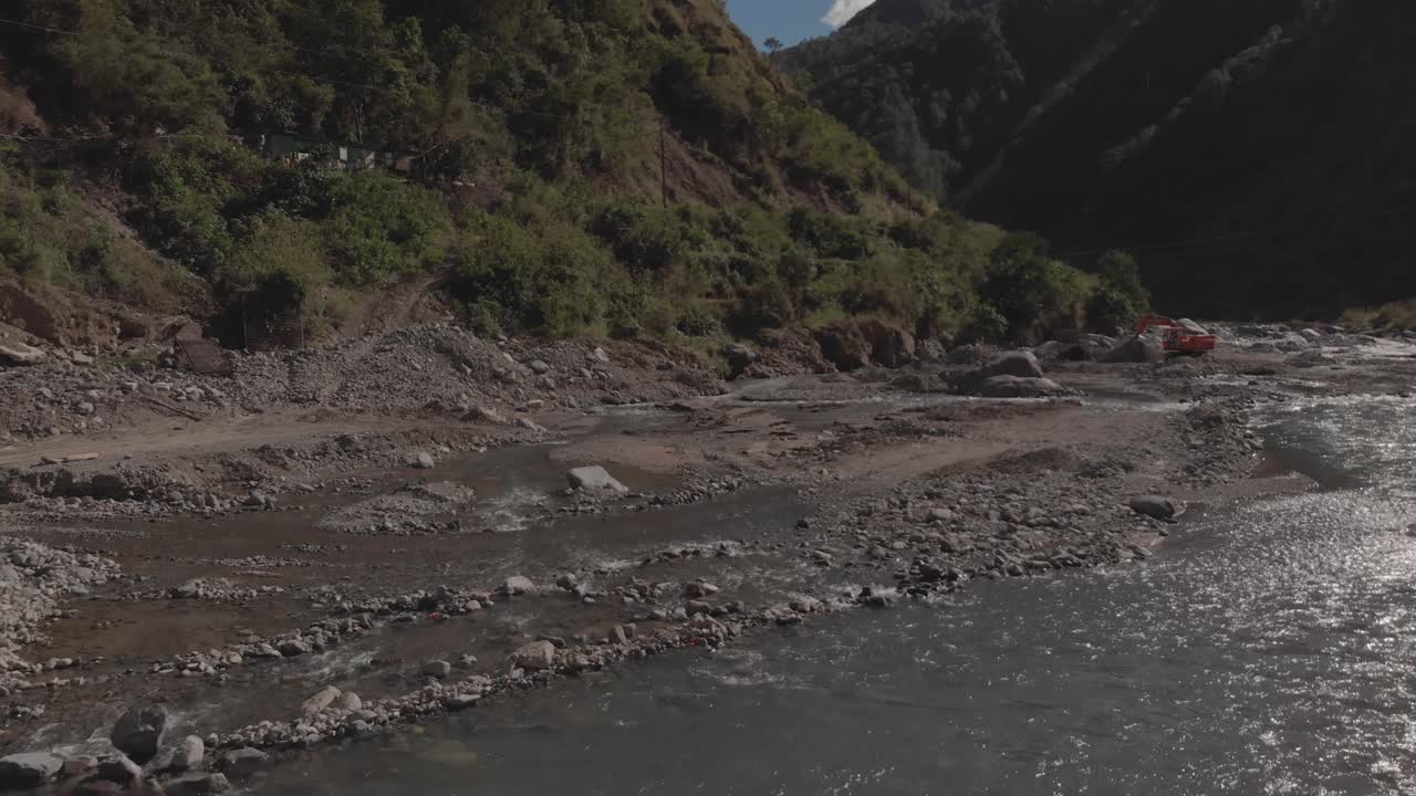 hermoso valle de montaña con agua de montaña esmeralda que fluye hacia atrás aérea revelando rocas de río rocas