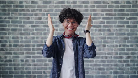 people with varied expressions in front of a brick wall