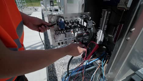 electrical engineers inspect the electrical systems at the equipment control cabinet