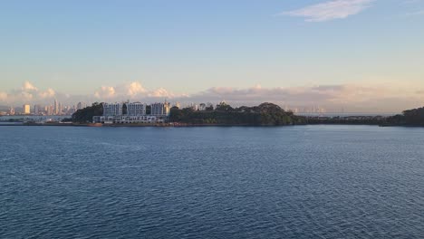 a beautiful aerial view captures the modern panama city skyline and coastal islands bathed in the warm, golden light of a spectacular sunrise or sunset over the pacific ocean.