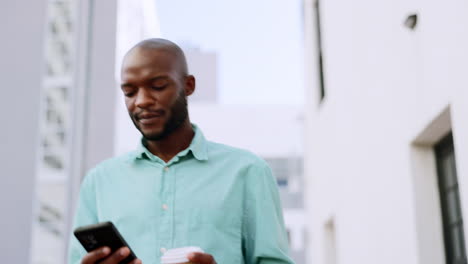 Phone,-coffee-and-black-man-walking-in-city