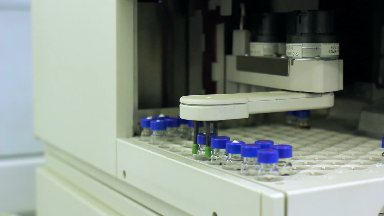 Robot arm take out flask from tray of research equipment. Research technology
