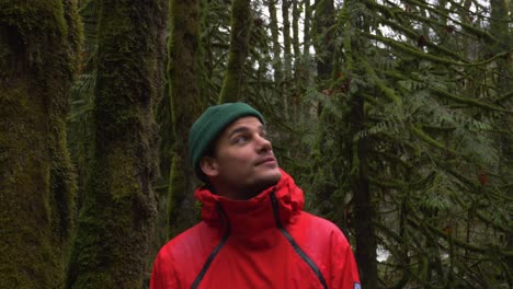 young man in awe by beauty in nature, close up in green lush forest